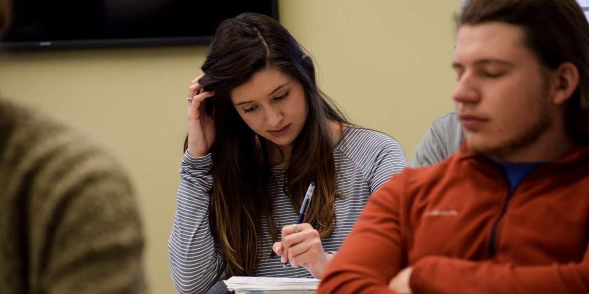 A student takes notes in class